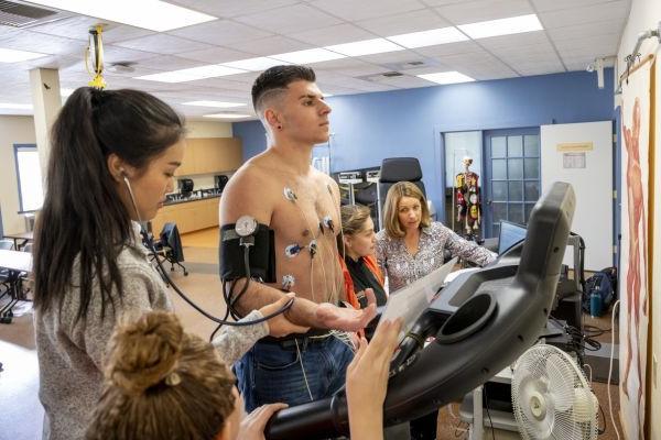 Students running a cardiac test